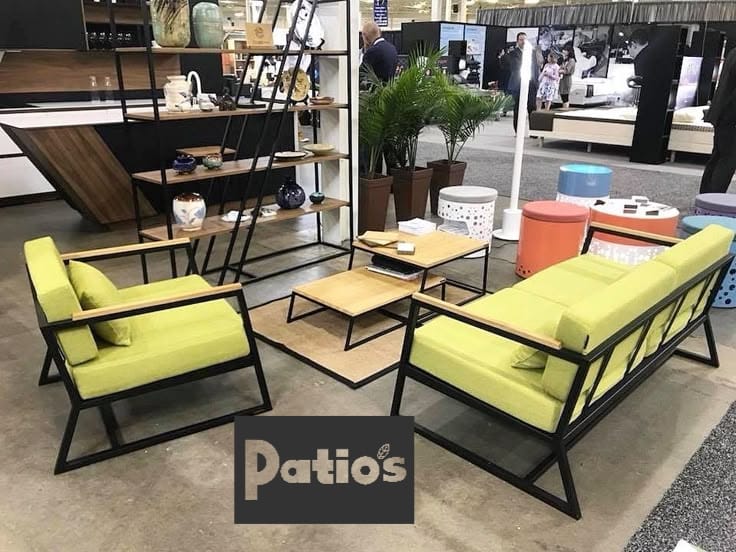 outdoor furniture set by Patios – black metal frame with wood accent and grey cushions (طقم حديقة من Patios بإطار معدني وخشب ووسائد رمادية)
