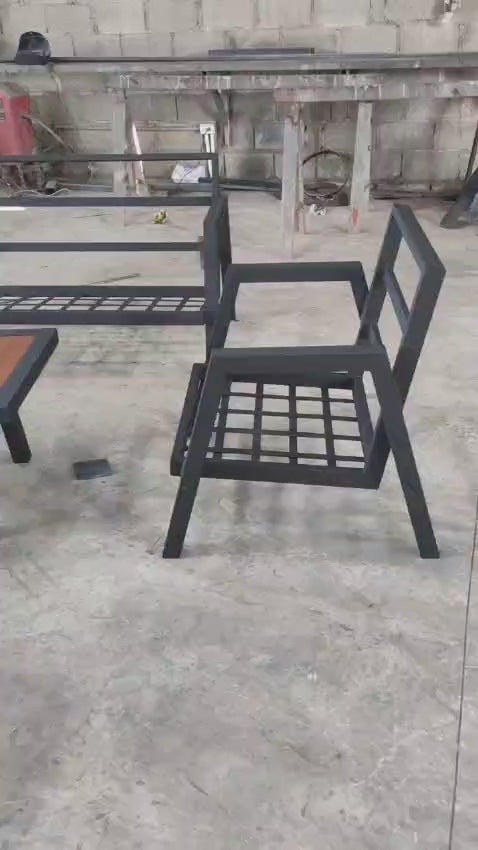 outdoor furniture set by Patios – black metal frame with wood accent and grey cushions (طقم حديقة من Patios بإطار معدني وخشب ووسائد رمادية)
